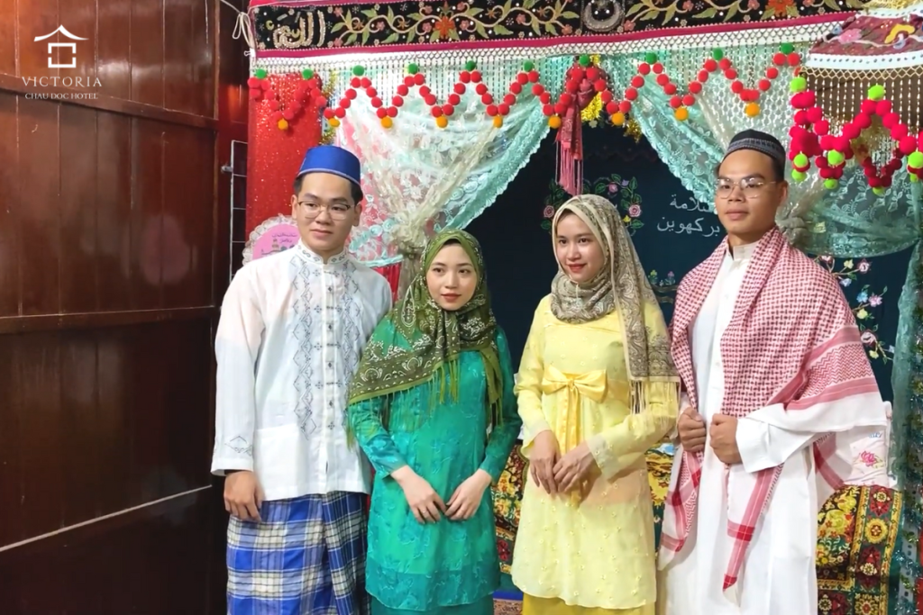 Visitors try traditional costoms worn by the Cham in An Giang.